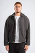 Man wearing a gray fleece jacket over a white shirt on a white background