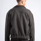 Person wearing a dark gray fleece jacket on a white background