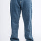 Blue jeans worn by a person on a white background
