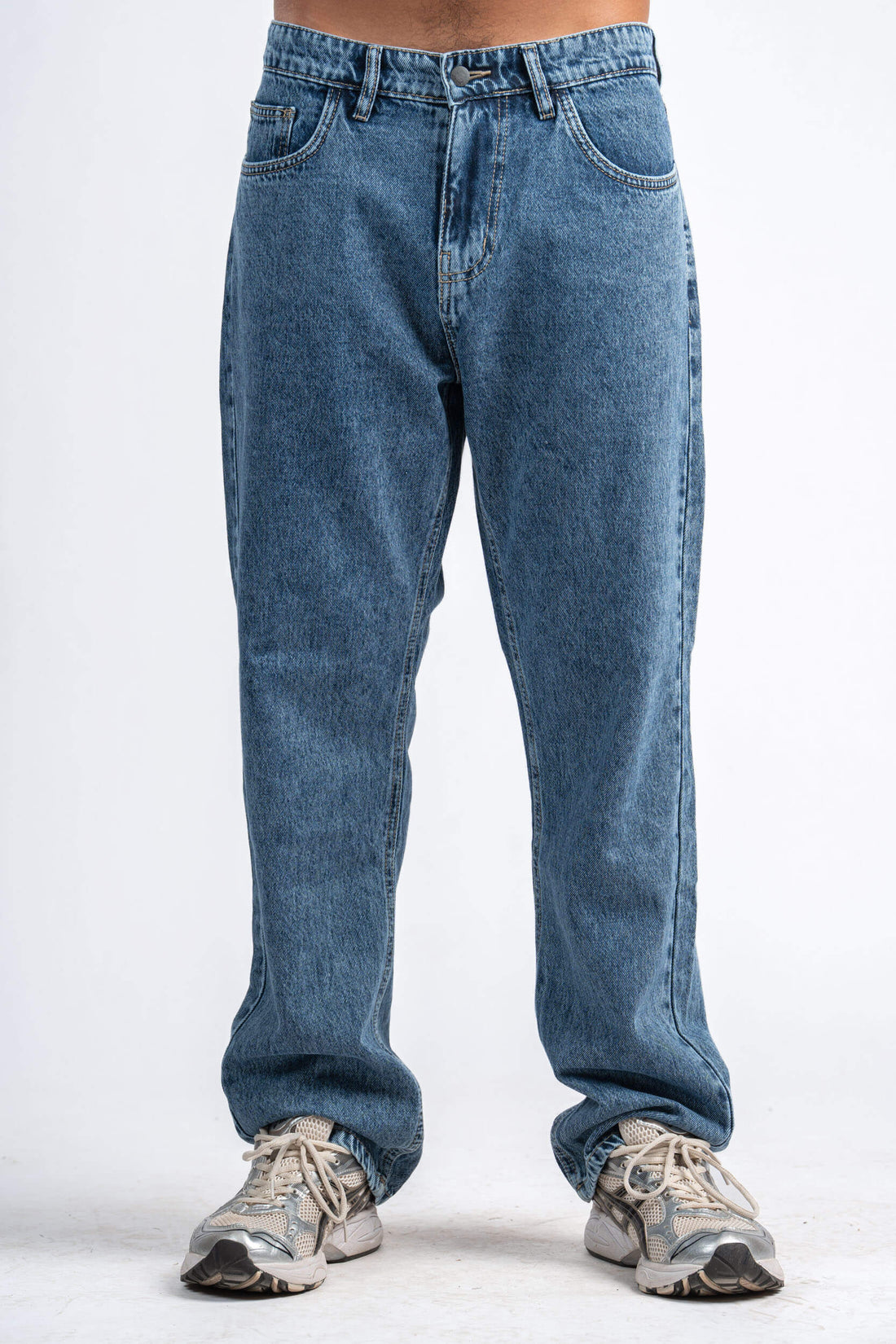 Blue jeans worn by a person on a white background