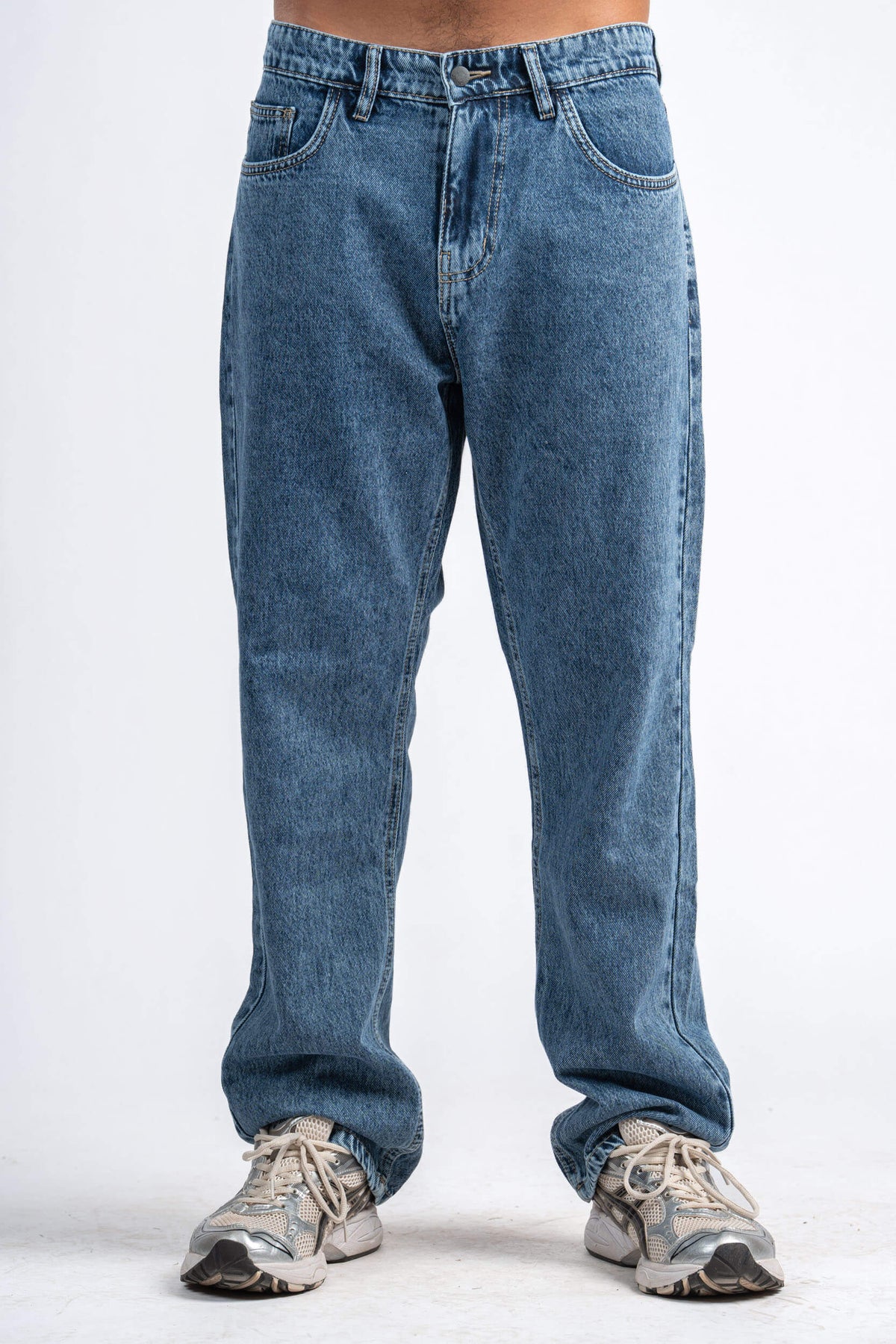 Blue jeans worn by a person on a white background