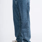 Blue jeans worn by a person on a white background