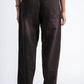 Brown pants worn by a person on a white background