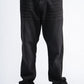 Person wearing black jeans on a white background