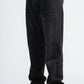 Black jeans worn by a person on a white background