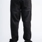 Black jeans worn by a person on a white background