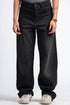 Person wearing black wide-leg jeans on a white background