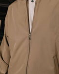 Close-up of a beige jacket with a zipper