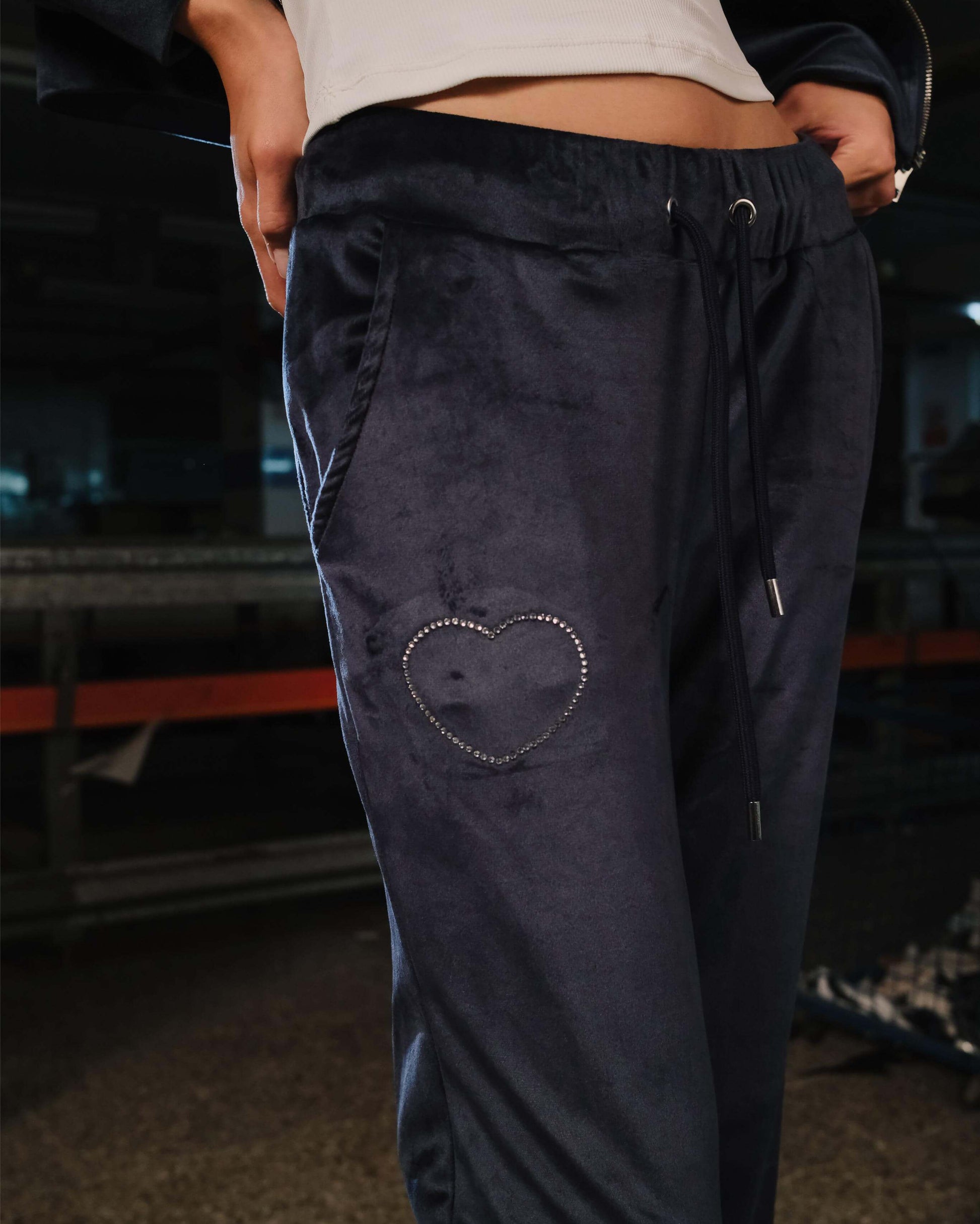 Navy blue pants with a heart design on a blurred background