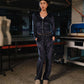 Person wearing a navy tracksuit in a workshop setting