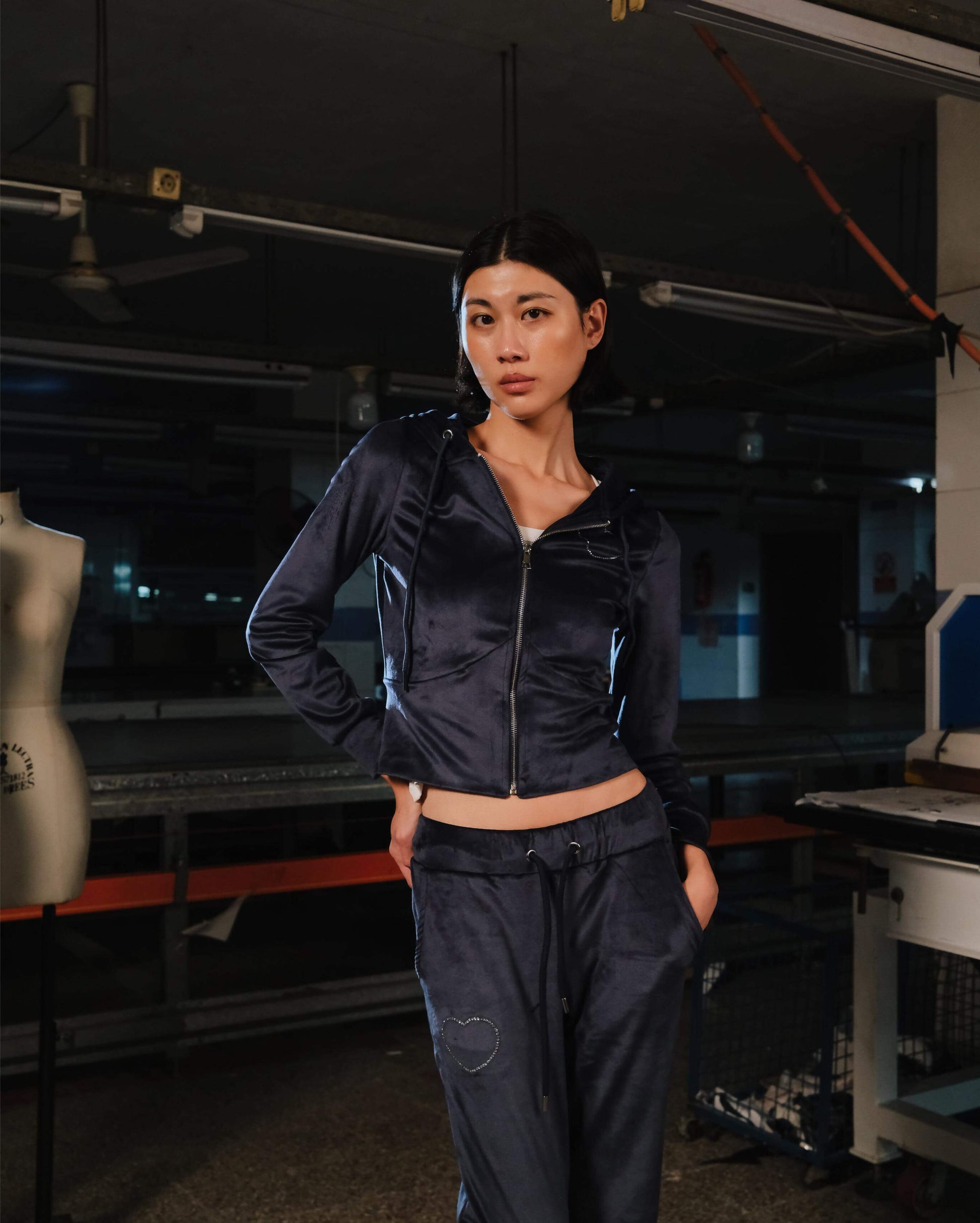 Woman wearing a black jacket and pants in an indoor setting