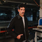 Man wearing a black jacket in an industrial setting