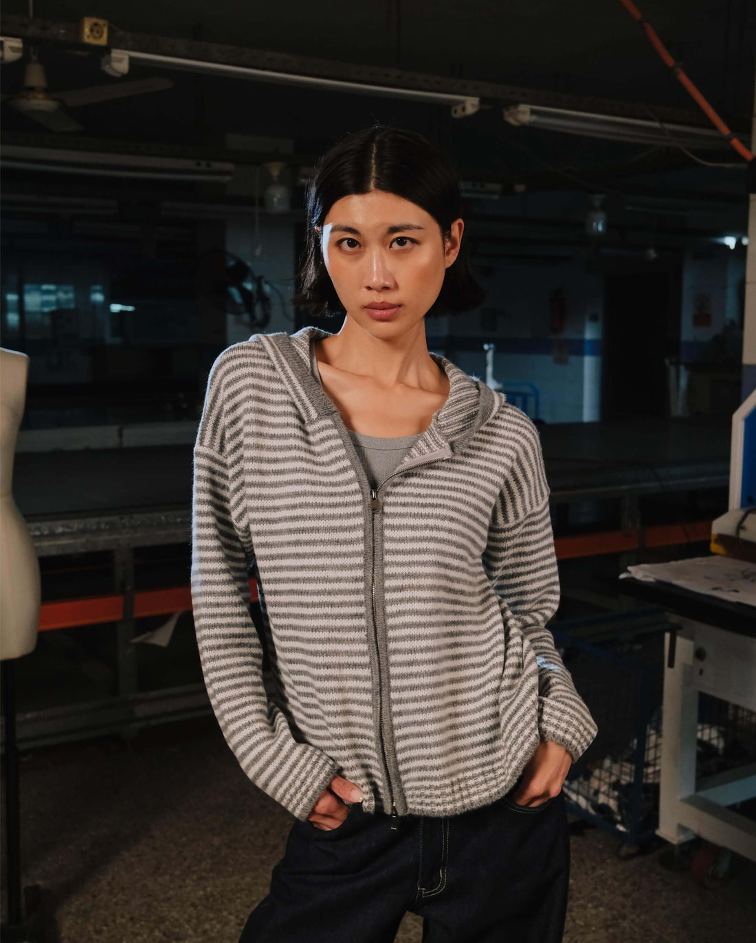 Woman wearing a striped hoodie in an indoor setting