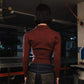 Person wearing a red shirt and dark pants in a garage setting