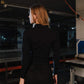 Person wearing a black outfit in an industrial setting