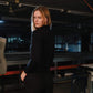 Person wearing a black outfit in an industrial setting