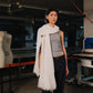 Person wearing a white scarf in an industrial setting
