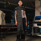 Person wearing a textured scarf and pants in an industrial setting
