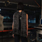 Person wearing a black and gray scarf in an indoor setting