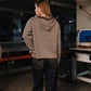 Person wearing a striped jacket in a workshop setting