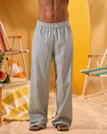 a man wearing a white tee and grey and white checkered lounge pants