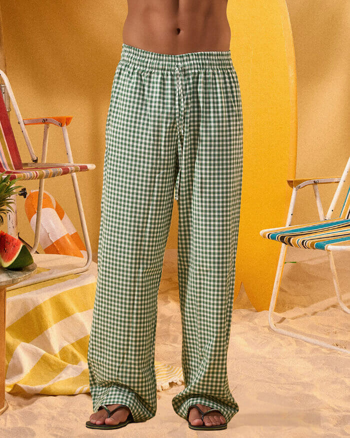 a man wearing a white tee and green and white checkered lounge pants