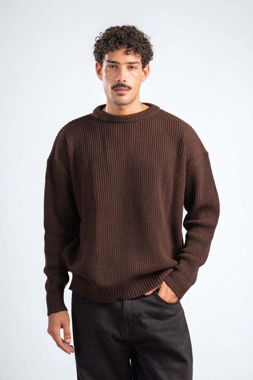 Man wearing a brown sweater against a white background
