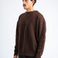 Man wearing a brown sweater against a white background
