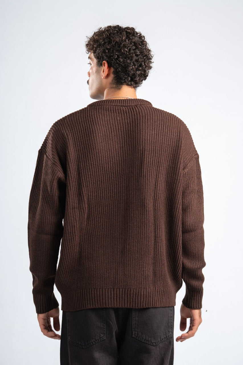 Man wearing a brown sweater against a white background