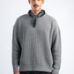 Man wearing a gray sweater with a black bandana around his neck on a white background