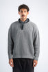 Man wearing a gray sweater with a black bandana around his neck on a white background