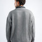 Man wearing a gray sweater on a white background