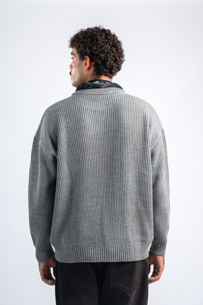 Man wearing a gray sweater on a white background