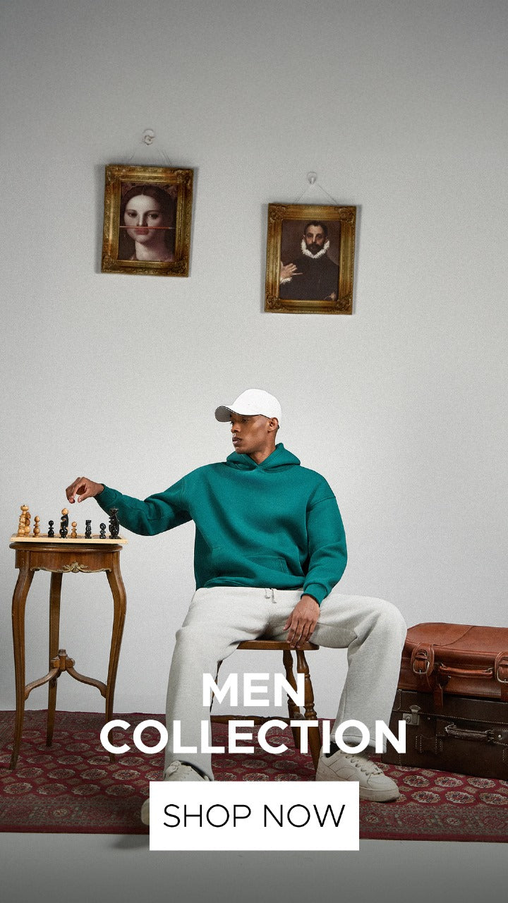 Man in teal hoodie and white pants