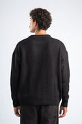 Person wearing a black sweater on a white background