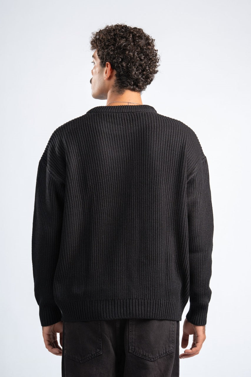 Person wearing a black sweater on a white background