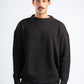 Man wearing a black sweater against a white background