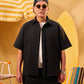 Man wearing sunglasses and a black shirt with a yellow background