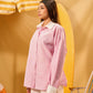 Woman wearing a pink striped shirt against a yellow background
