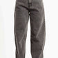 Gray jeans worn by a person on a white background