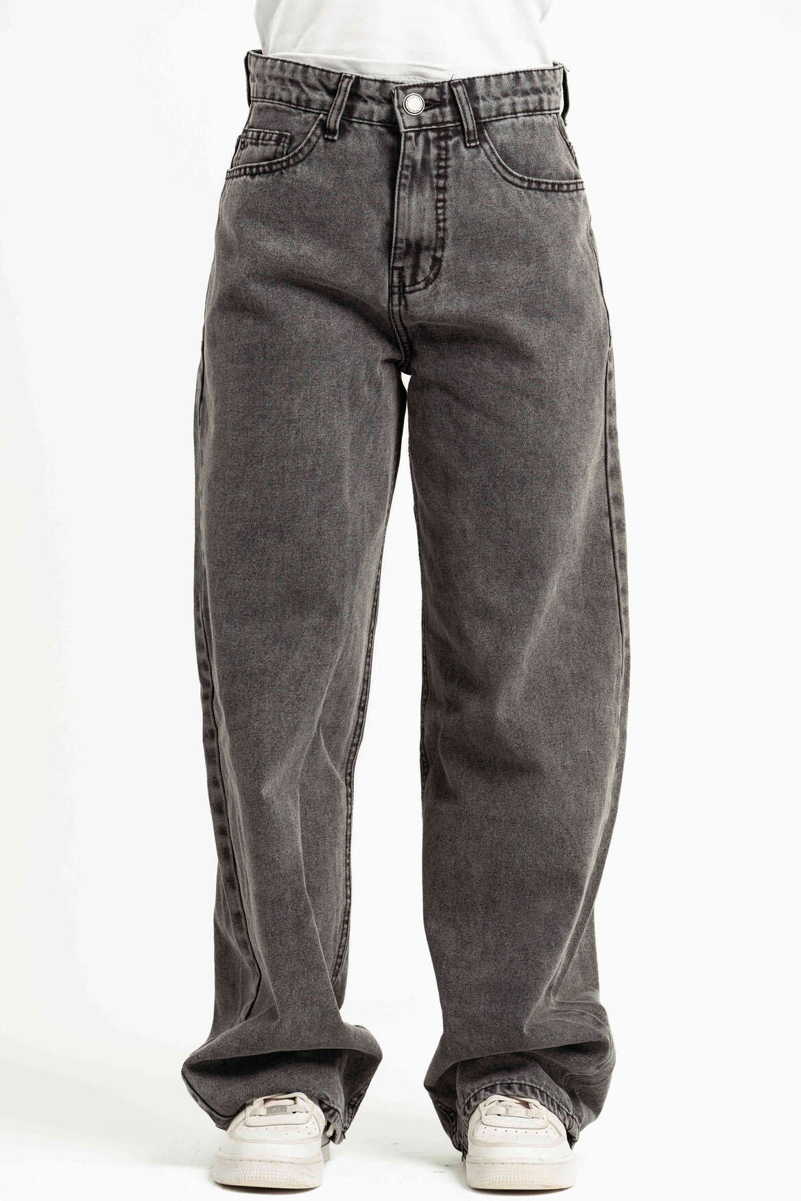 Gray jeans worn by a person on a white background