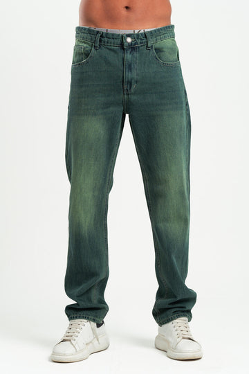 Green jeans worn by a person on a white background