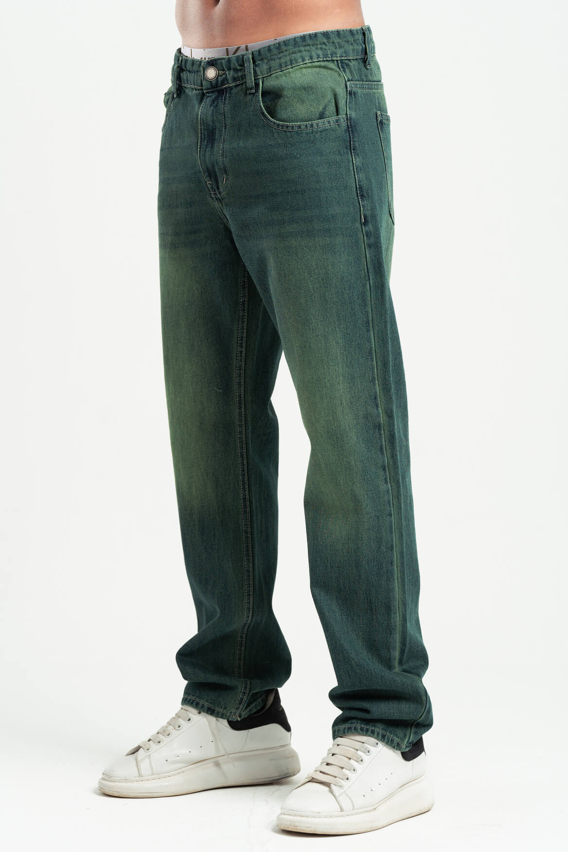 Green jeans worn by a person on a white background