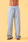 a man wearing a blue and white checkered lounge pants