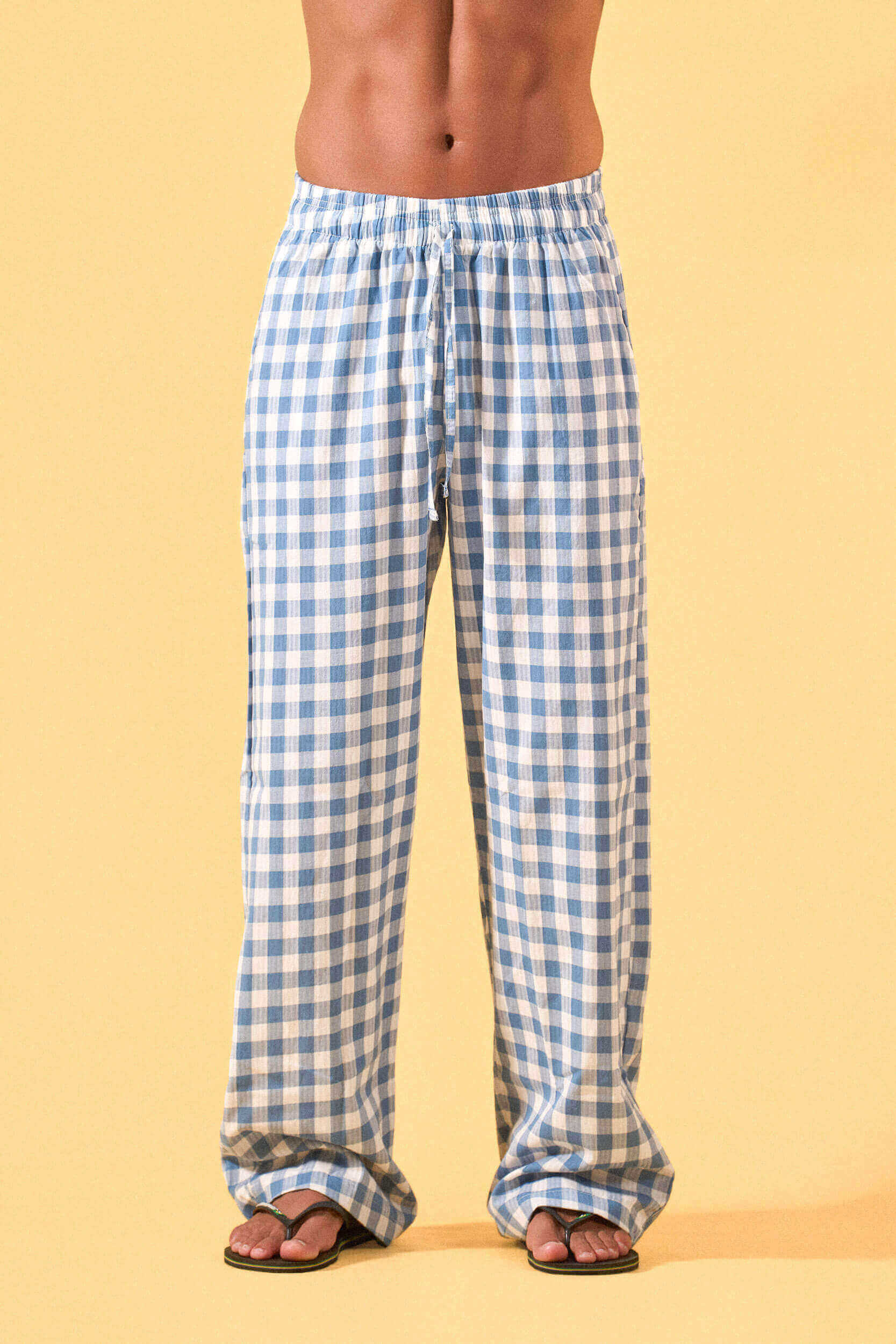 a man wearing a blue and white checkered lounge pants