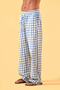 a man wearing a blue and white checkered lounge pants