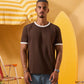 a man wearing a brown  t-shirt with contrast white neckline and sleeve trim 
