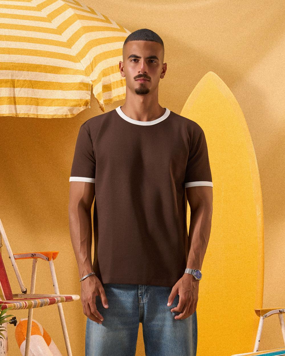 a man wearing a brown  t-shirt with contrast white neckline and sleeve trim 