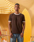 a man wearing a brown  t-shirt with contrast white neckline and sleeve trim 