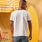 a man wearing an off-white t-shirt with a contrast brown neckline and sleeve trim 